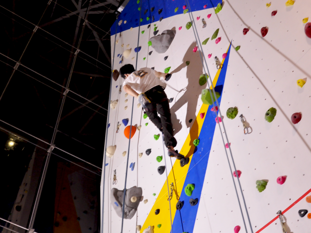 man rock climbing at night 